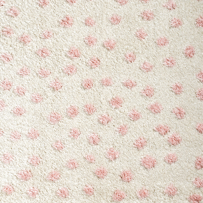 close up image of cream and pink super soft spotted rug