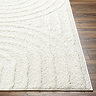 close up image on corner of soft cream lined rug