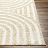 close up image of corner of soft yellow rug with arch line pattern