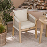 close up image of woven rope dining table tucked under round acacia wood bistro table