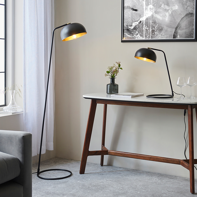 image of matt black tall floor lamp with domed head next to console table with matching matt black table lamp on it