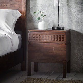 image of brown bedside table with bohemian inlay design, next to bed