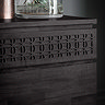 close up image on frieze of front of black sideboard drawers