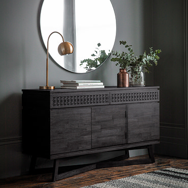 close up image on frieze of front of black sideboard drawers
