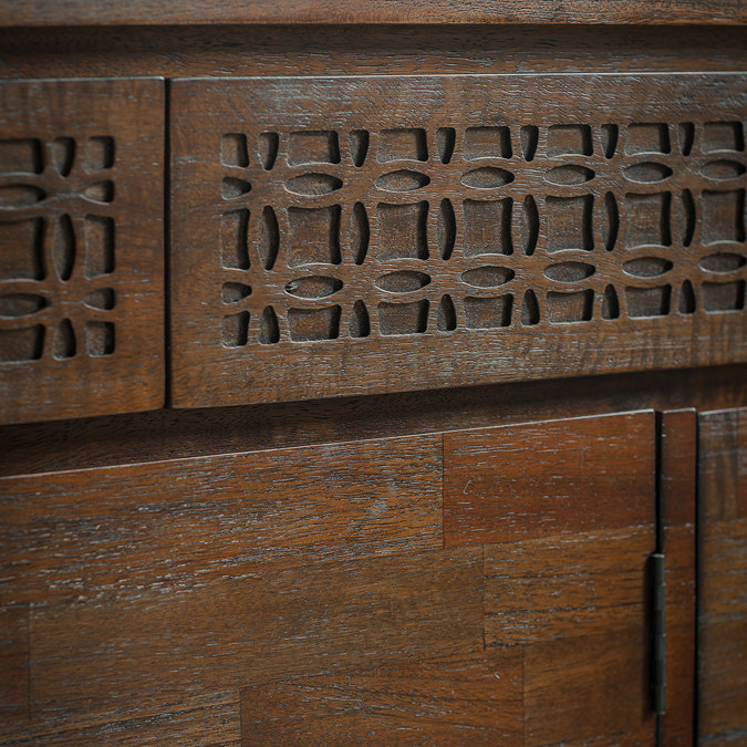 super close up image of frieze on warm brown sideboard