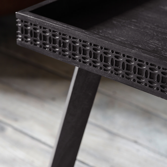 close up on bohemian frieze pattern of black coffee table