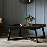 image of black wooden coffee table with bohemian frieze pattern, on wooden flooring