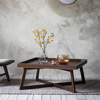 image of square brown coffee table with frieze pattern round the front