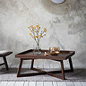 image of square brown coffee table with frieze pattern round the front