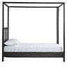 side on image cut out on white background of four poster black bed