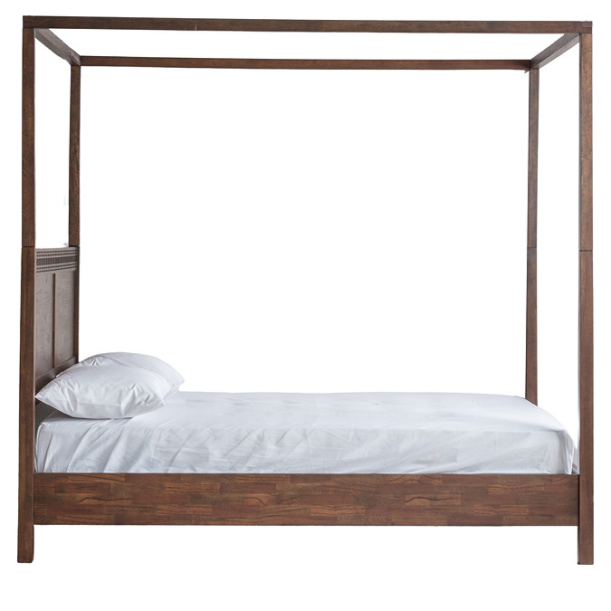 side on cut out of brown wooden four poster bed