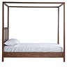 side on cut out of brown wooden four poster bed