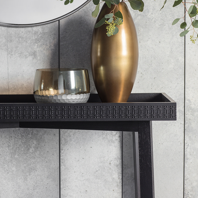 front on close up image of black wooden console table with frieze pattern