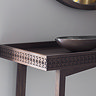 close up on corner of warm brown wooden console table