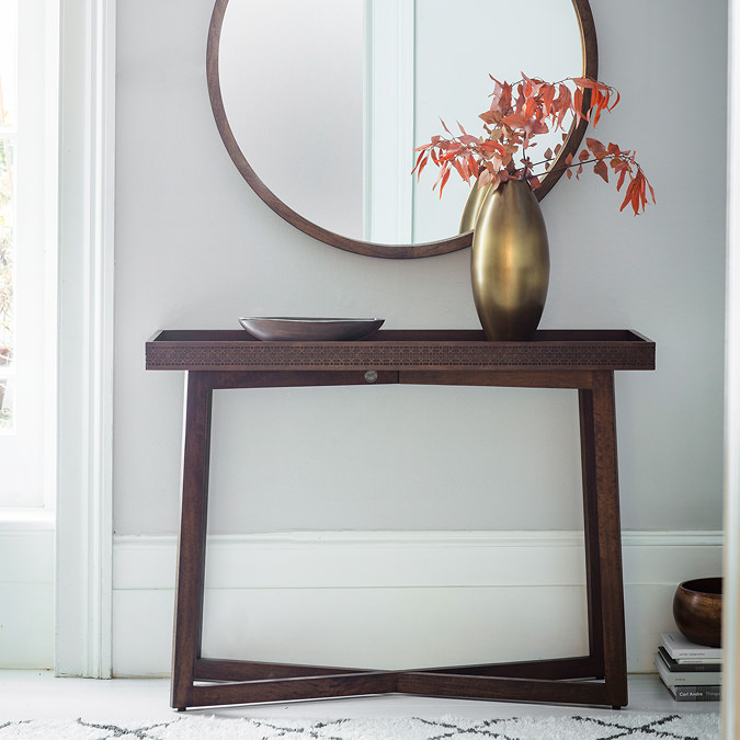 image of brown console table with frieze across the front and cross legs