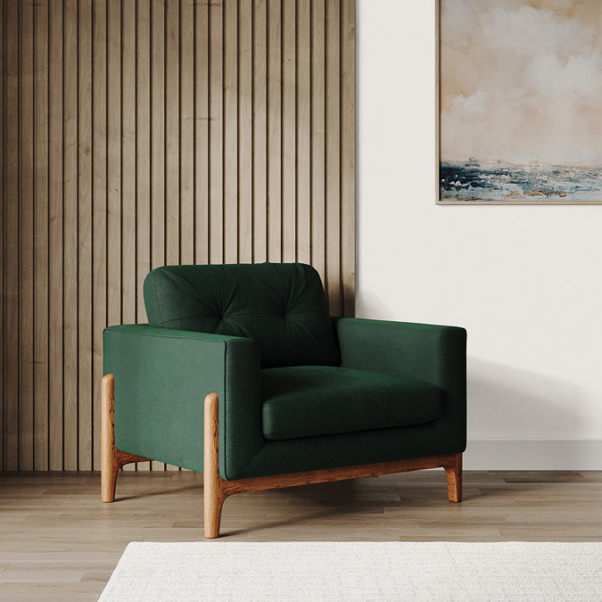 lifestyle image of green velvet armchair with light ash feet