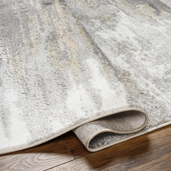 close up image on folded edge grey abstract rug to suggest its thickness