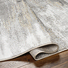close up image on folded edge grey abstract rug to suggest its thickness