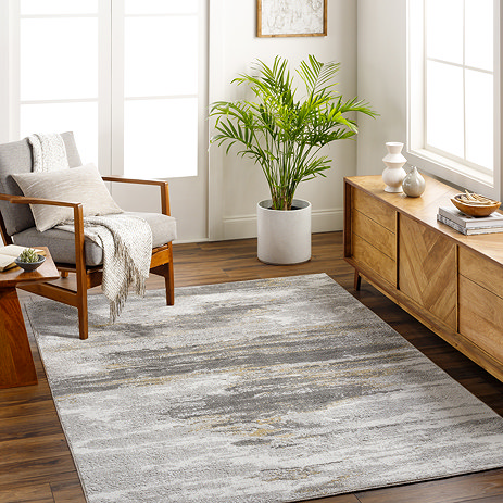 image of abstract grey rectangular rug on wooden flooring of modern apartment under grey armchair