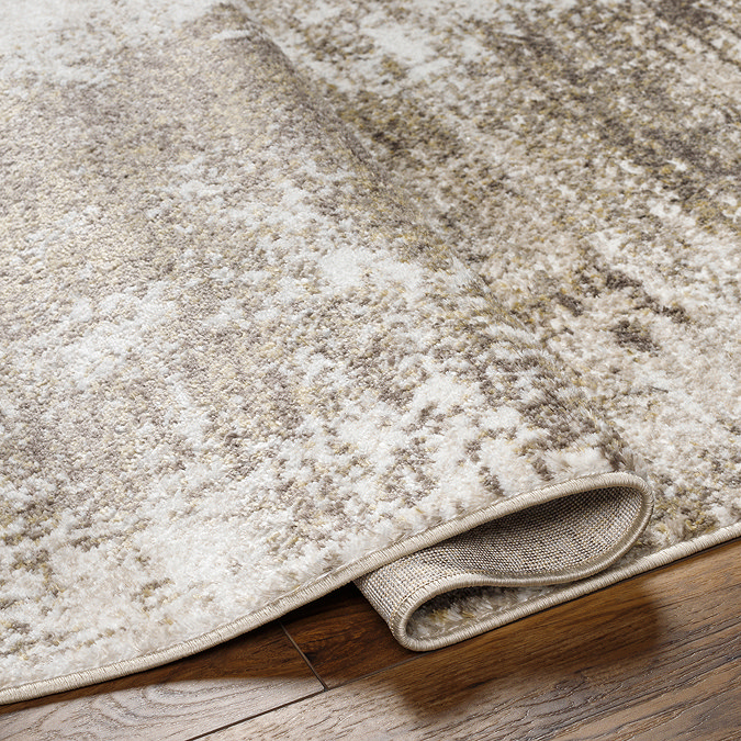 image of folded edge of brown marbled rug to suggest its thickness/height