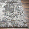 close up image of corner of grey marbled rug on dark wooden flooring