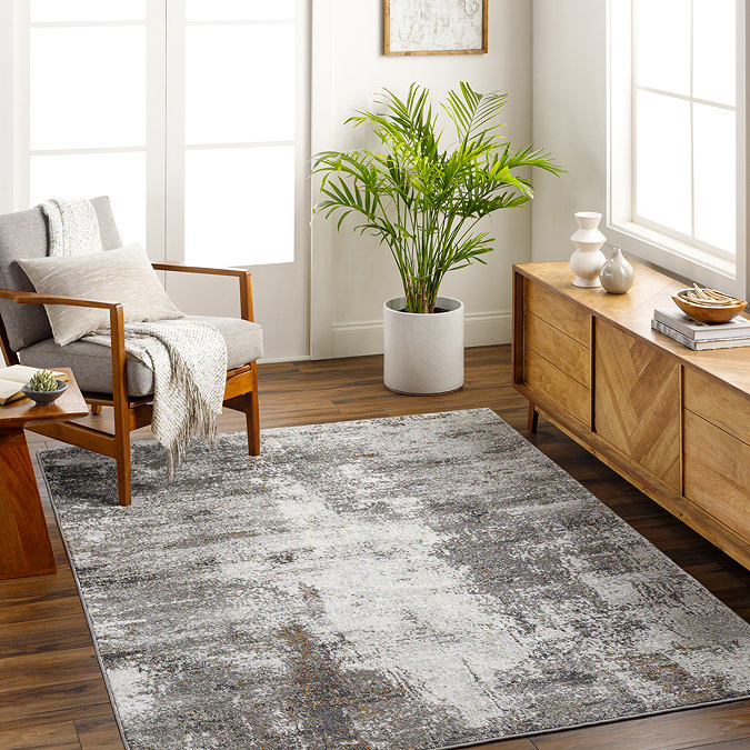 image of dark grey marbled rug on dark wooden flooring of modern apartment