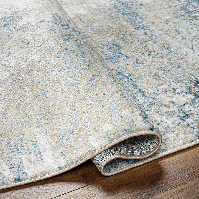 close up image on folded edge of teal rug