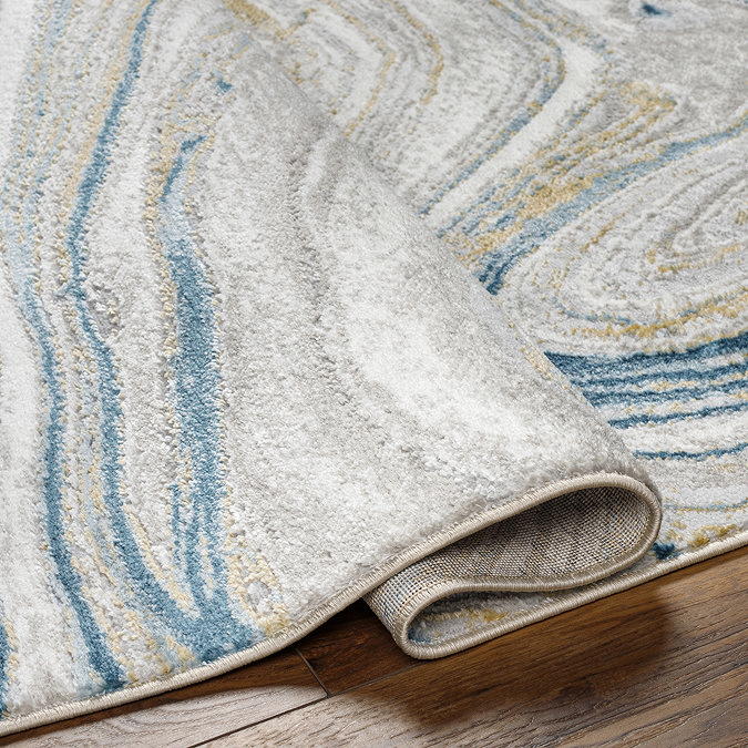 image of folded edge of teal rug to suggest its thickness/height