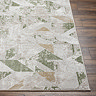 image of corner of sage and ivory geometric rug on wooden flooring