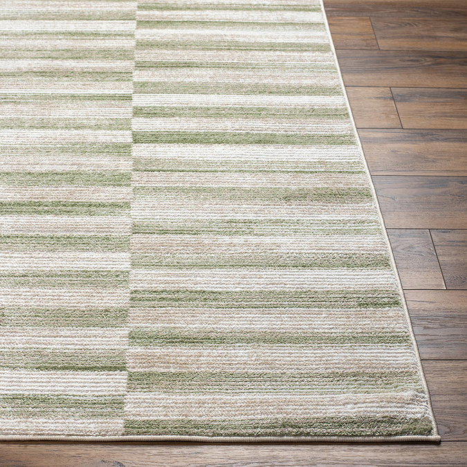close up image on corner of striped modern green rug
