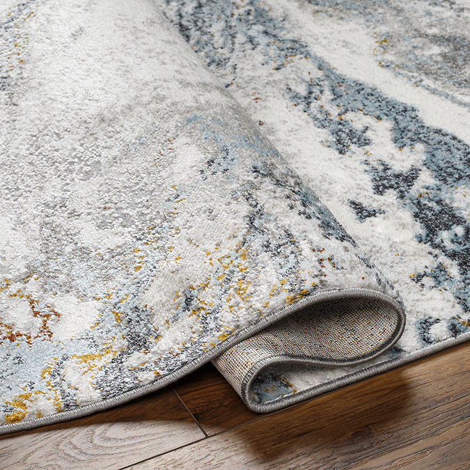 image of blue and grey marbled rug folded over slightly to suggest its thickness