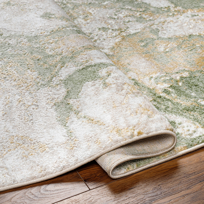 close up image of green marbled rug sightly folded over to suggest its thickness