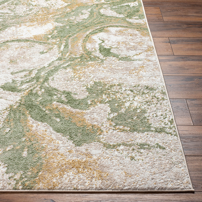 close up image of corner of green marbled rug on wooden flooring