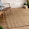 image of jute effect patterned rug on natural flooring of living room with chair at its corner