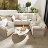 image angled slightly from above of luxury garden lounge set with deep cushions and cream stone topped coffee table