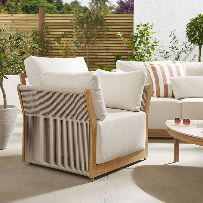 close up image of garden armchair with deep cream cushion and rope sides
