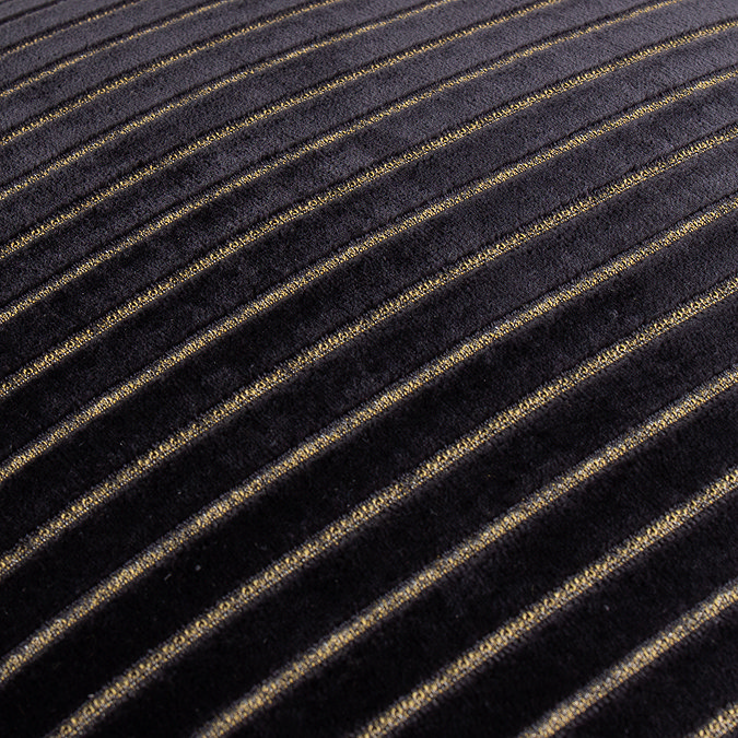 close up on black velvet cushion with gold striped pattern