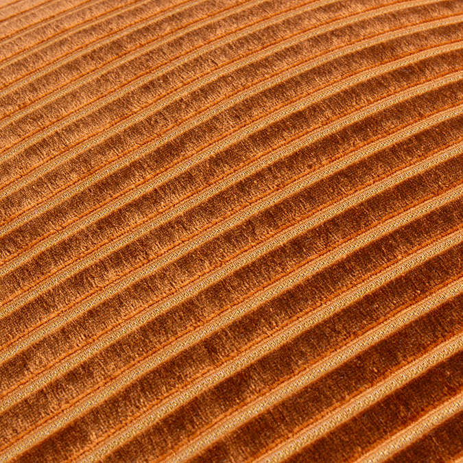 close up on orange cushion with gold striped detail pattern