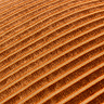 close up on orange cushion with gold striped detail pattern