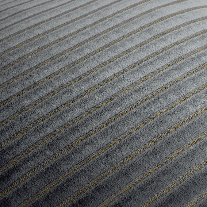 close up on grey cushion with gold stripe pattern detail