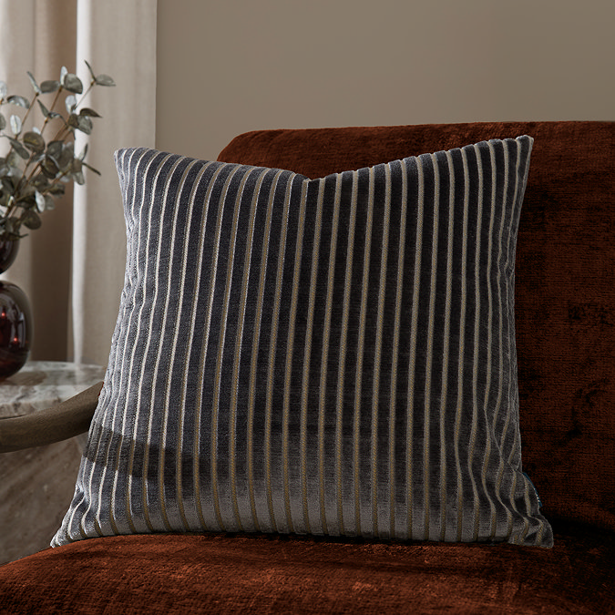 55x55cm charcoal grey cushion with vertical stripe detail, sat on rust orange armchair
