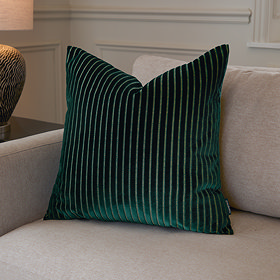 55x55cm emerald green cushion with vertical stripe detail, sat in corner of cream sofa