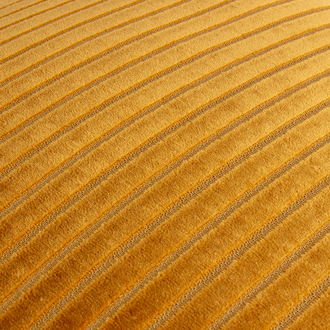 close up image on yellow gold cushion with stitch detail pattern