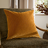 55x55cm gold cushion with vertical stripe detailing, sat on dark khaki chair
