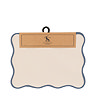 image cut out on white background of cream placemat with blue scalloped border