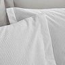 Seersucker woven stripe bedding in grey close up on bed image 4