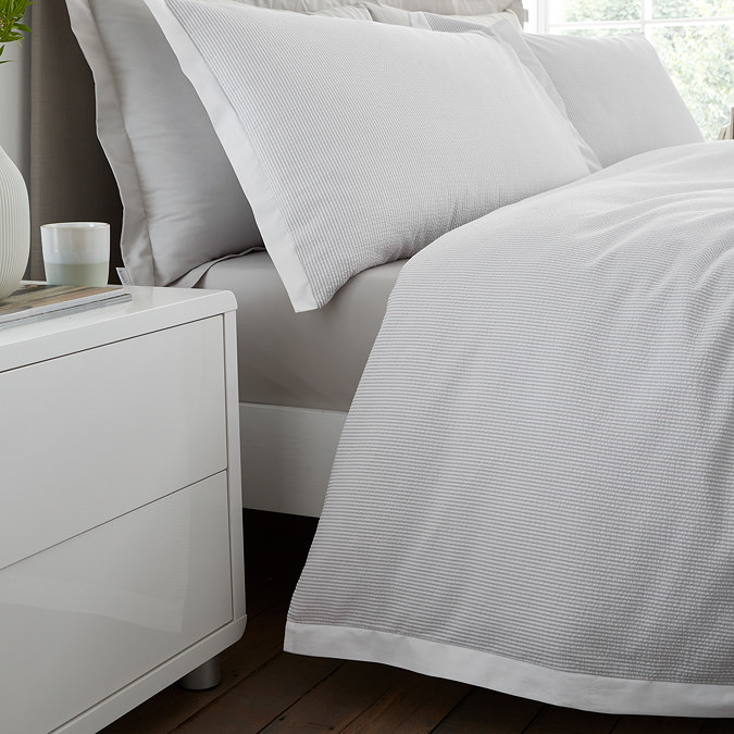 Seersucker woven stripe bedding in grey close up on bed image 5