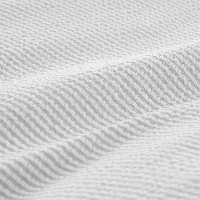 Seersucker woven stripe bedding in grey close up on bed image 6