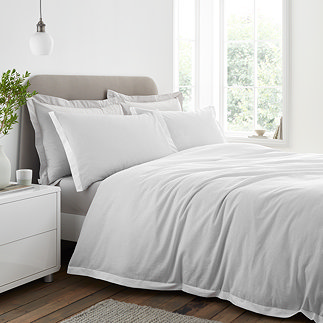 Seersucker woven stripe bedding in grey on bed image 1