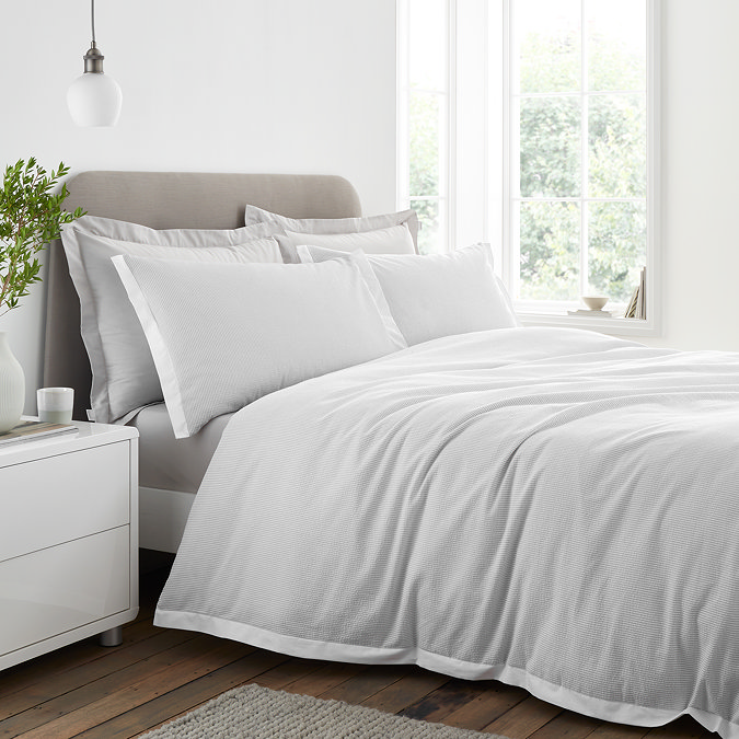 Seersucker woven stripe bedding in grey on bed image 1